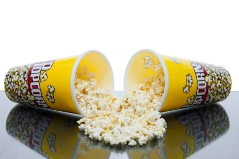 Two cups of spilled popcorn Stock Photos