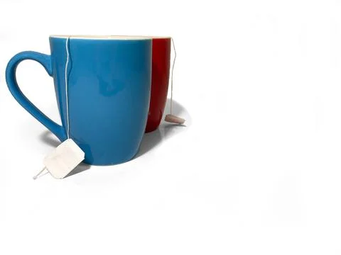 Two cups stand side by side on a white background. Stock Photos