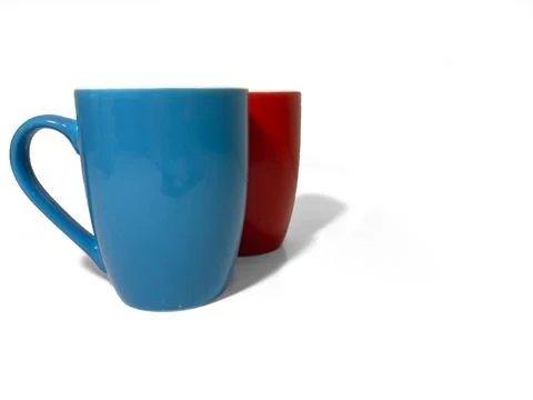Two cups stand side by side on a white background. Red and blue Stock Photos