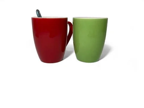 Two cups stand on a white background. Red and green cups. Stock Photos
