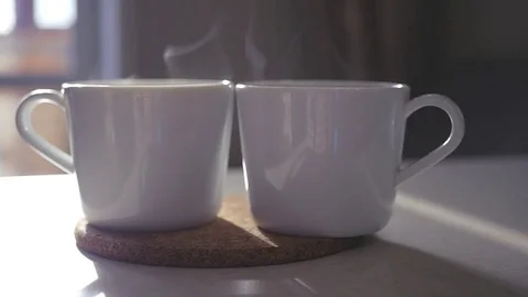 Two cups of steaming coffee stand on the table. slowmotion. 1920x1080 Stock Footage 75038266