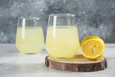 Two cups of tasty lemonade with lemon slices Stock Photos