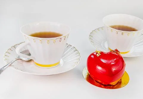 Two cups of tea and a cake in the form of a heart. Valentine's Day Stock Photos