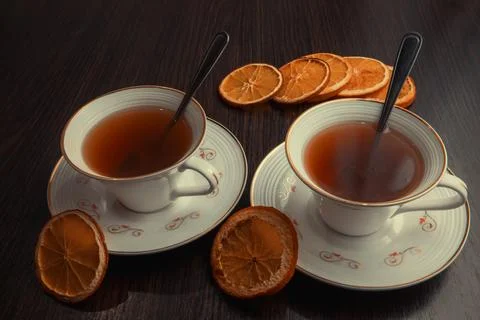 Two cups of tea with dried oranges Stock Photos