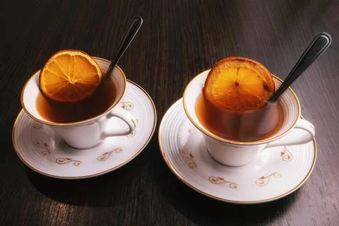 Two cups of tea with dried oranges Stock Photos