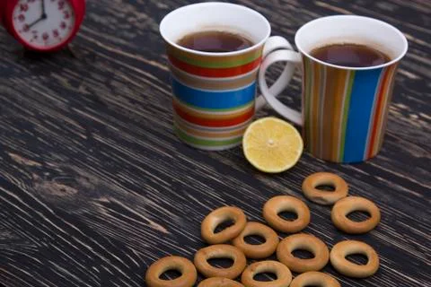 Two cups for tea with fragrant bagels on  wooden background Stock Photos