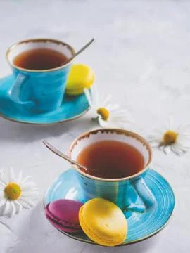 Two cups of tea with macaroons. Stock Photos