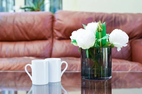 Two cups of tea or coffee together on a coffee table in a light home interior Stock Photos