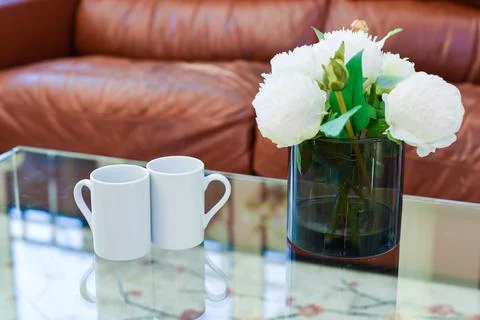 Two cups of tea or coffee together on a coffee table in a light home interior Stock Photos
