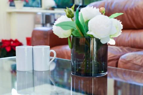 Two cups of tea or coffee together on a coffee table in a light home interior Stock Photos