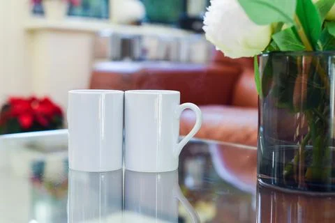 Two cups of tea or coffee together on a coffee table in a light home interior Stock Photos