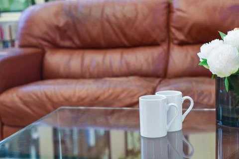 Two cups of tea or coffee together on a coffee table in a light home interior Stock Photos