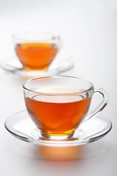 Two cups of tea over white background Stock Photos