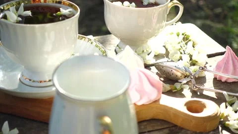 Two cups of tea on a wooden table at the spring garden Stock Footage 173686515