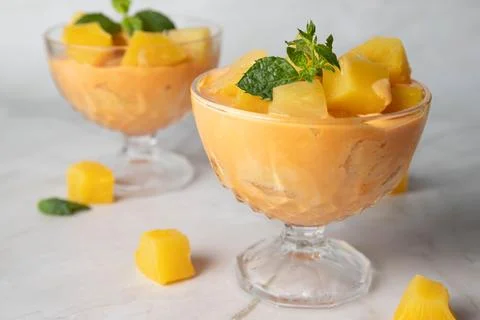 Two cups  whith yellow ice cream with mango, pineapple, cantaloupe flavor, Stock Photos