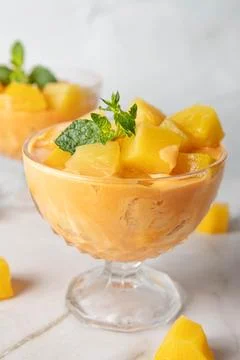 Two cups  whith yellow ice cream with mango, pineapple, cantaloupe flavor, Stock Photos