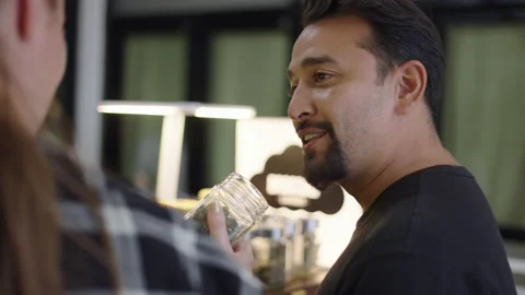 Two customers smelling and checking cannabis flowers quality before buying it Stock Footage 236456513