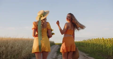 Two cute blondes are walking in the field Stock Footage 211904242