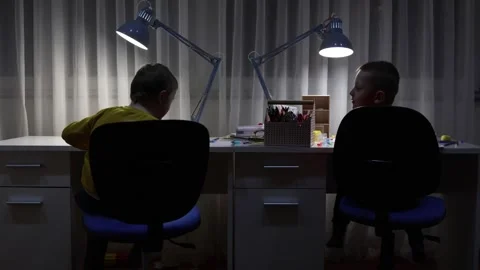 Two cute boys sitting at a desk Stock Footage 300503164