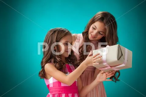 The two cute cheerful little girls on blue background Stock Photos