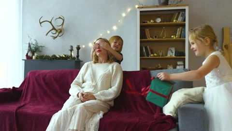 Two cute daughters arranged a surprise for their mom Stock Footage 194741882