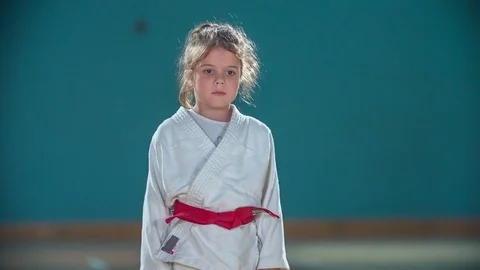 Two cute girls take a bow and shake hands before a judo session Stock Footage 78533705