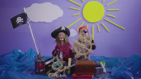 Two cute kids with props acting pirates on sea scene, children playing game, 4k. Stock Footage 104110214