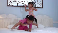 Two little girls in leggings jumping on , Stock Video