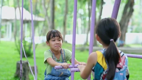 Two cute little sisters having fun playing in the playground during summer. 動画素材 241543280