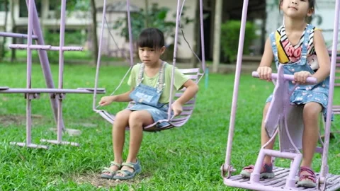 Two cute little sisters having fun playing in the playground during summer. Stock Footage 241543285