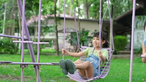 Two cute little sisters having fun playing in the playground during summer. Stock Footage 241543288