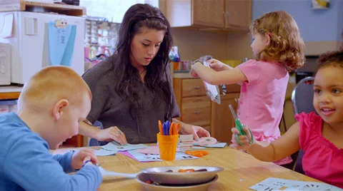 Two cute school children work on a project at a table together during art class Video stock 34004821