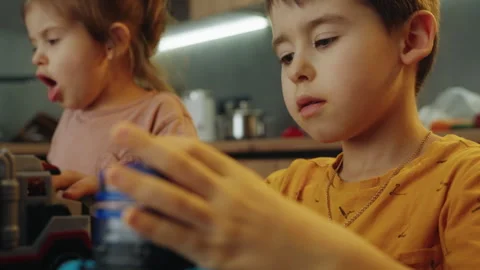 Two cute small kids playing with multicolored car toys. Little kids have a fun Stock Footage 264022126