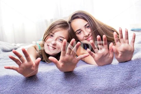 Two cute teenage girls having fun with nail care. Girls, friends activity Stock Photos