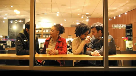 Two cute young couples sharing coffee together and talking Stock Footage 34002549