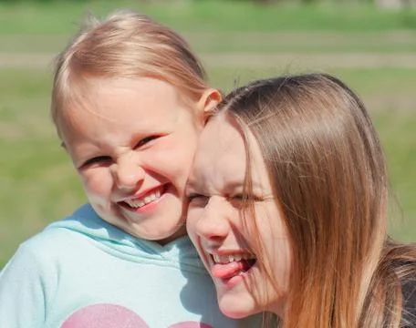 Two cute young girls having fun, smiling Stock Photos