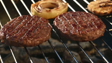 Two cutlets fried on a barbecue grill with onions Stock Footage 139869099