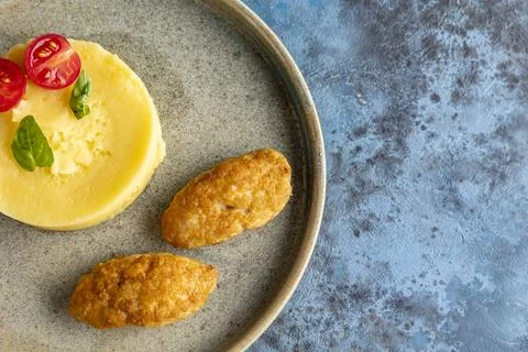 Two cutlets with mashed potatoes and measure. Restaurant service. Stock Photos