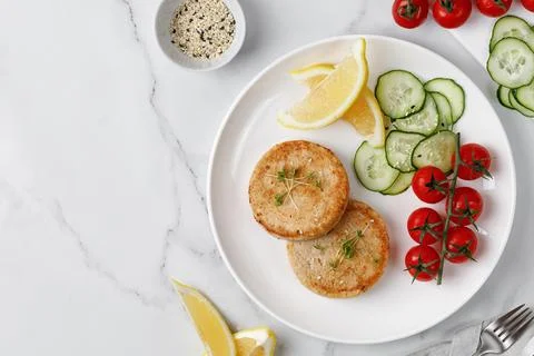 Two Cutlets, patties with tomatoes cherry, cucumbers. Healthy food dinner i.. Stock Photos
