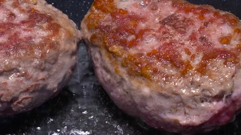 Two cutlets, two steaks are fried in boiling oil in a hot pan. Non-stick fryi Stock Footage 149754765