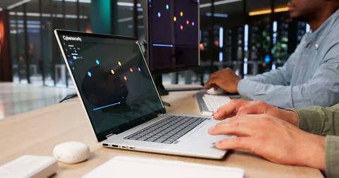 Two Cybersecurity Analysts Using Laptop To Detect Threats And Manage Data. 스톡 사진