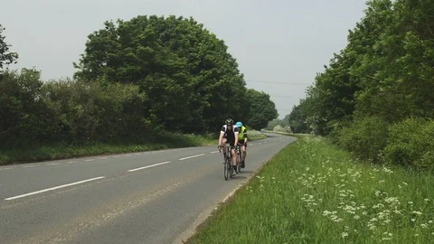 Two Cyclist Riding Down A Country Road Stock Footage 90309524