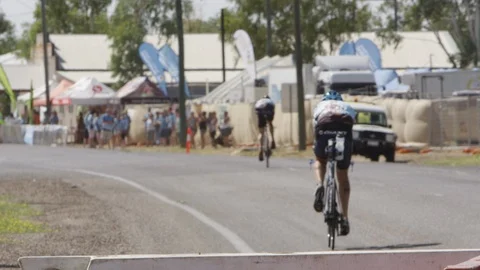 Two cyclists approaching a crowd Stock Footage 91723248