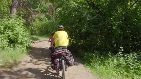Two cyclists on a forest trail. Two guys with backpacks on bicycles Stock Footage 158716925