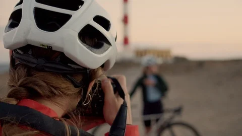 Two cyclists make photos at sunset Stock Footage 108977507