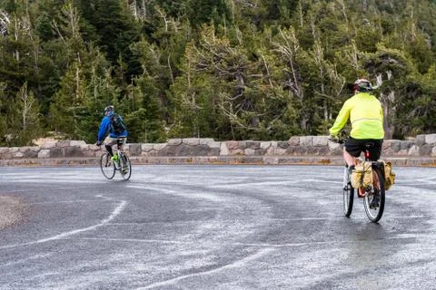 Two cyclists make a route around Crater Lake Stock Photos