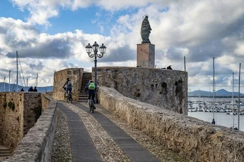 Two cyclists in the marina of Alghero Stock Photos