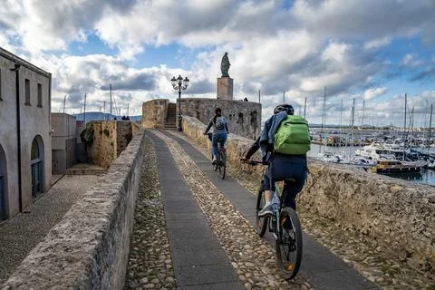 Two cyclists in the marina of Alghero Stock Photos