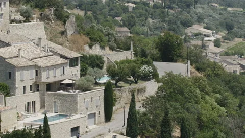 Two Cyclists in a Mediterranean Town. Extreme Long Shot Stock Footage 88884937