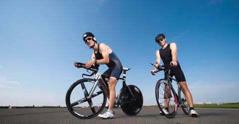 Two cyclists pausing on their racing bicycles Stock Photos